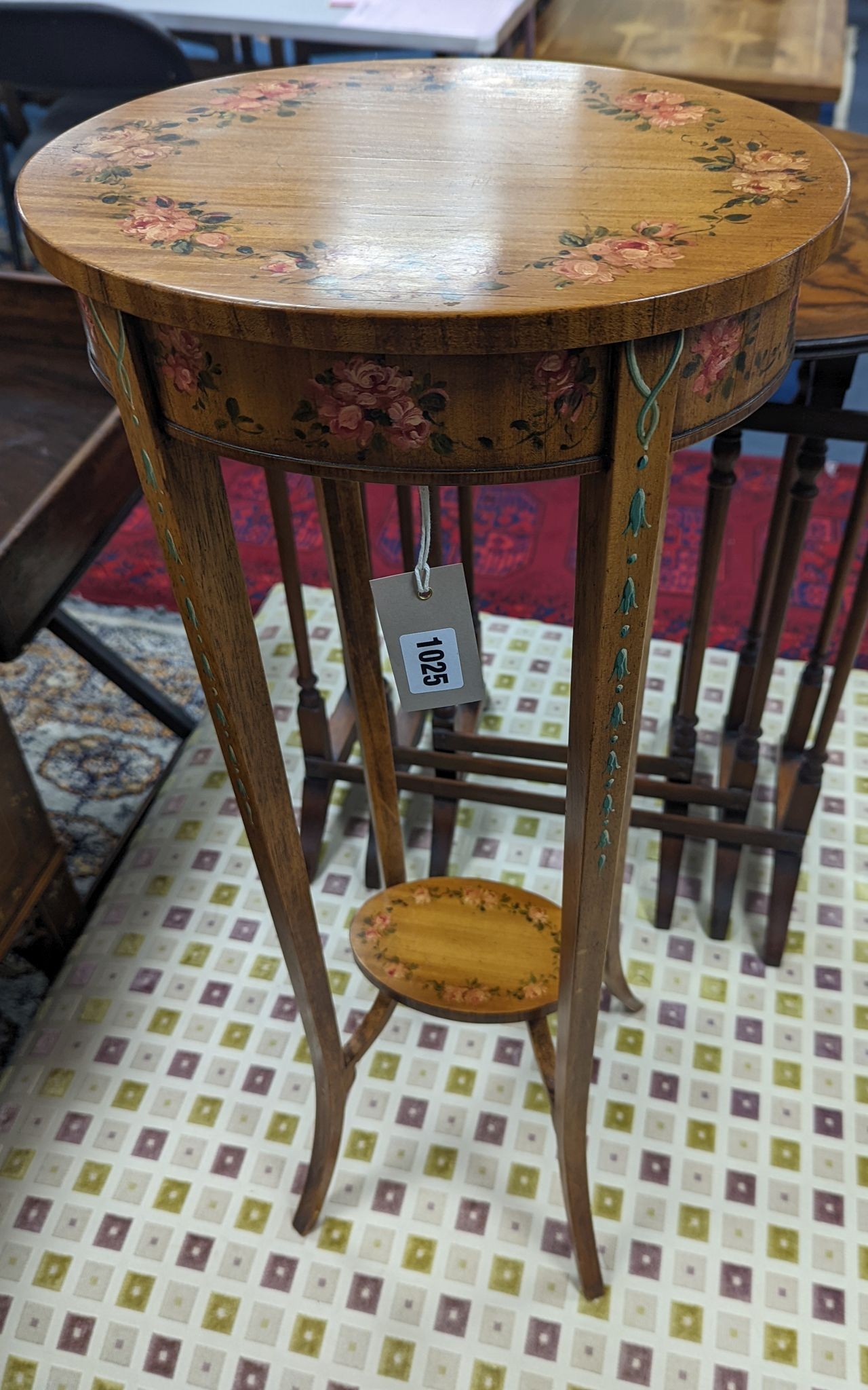 A small Sheraton style oval painted satinwood two tier plant stand, width 30cm, depth 25cm, height 73cm